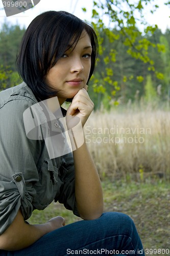 Image of young sad woman in the forest