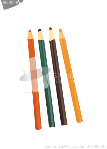 Image of four colored pencils across white