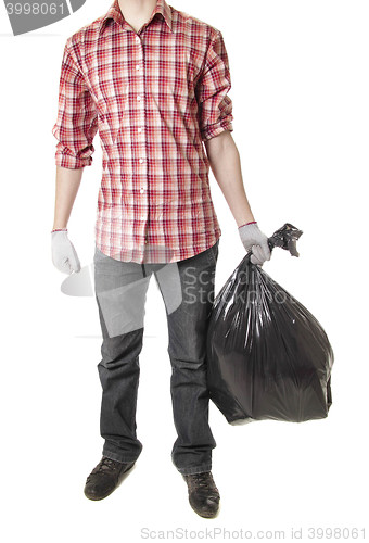 Image of Man holding black plastic trash bag