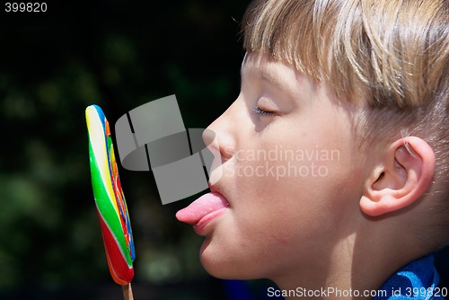 Image of boy licking a lollipop