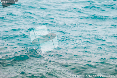 Image of Photo closeup of beautiful clear turquoise sea ocean water surface with ripples low waves on seascape background, horizontal picture