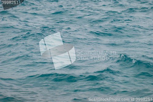 Image of Photo closeup of beautiful clear turquoise sea ocean water surface with ripples low waves on seascape background, horizontal picture