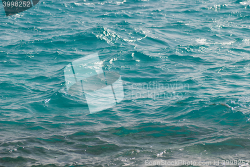 Image of Photo closeup of beautiful clear turquoise sea ocean water surface with ripples low waves on seascape background, horizontal picture