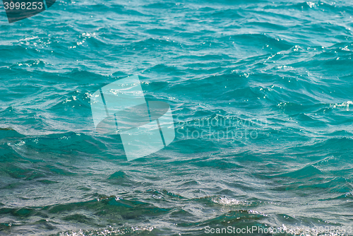 Image of Photo closeup of beautiful clear turquoise sea ocean water surface with ripples low waves on seascape background, horizontal picture