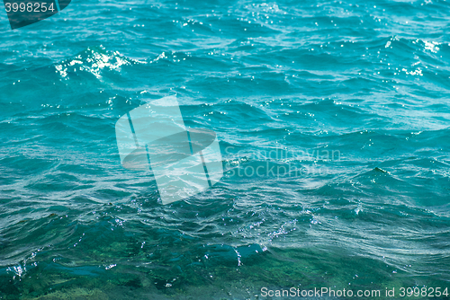 Image of Photo closeup of beautiful clear turquoise sea ocean water surface with ripples low waves on seascape background, horizontal picture