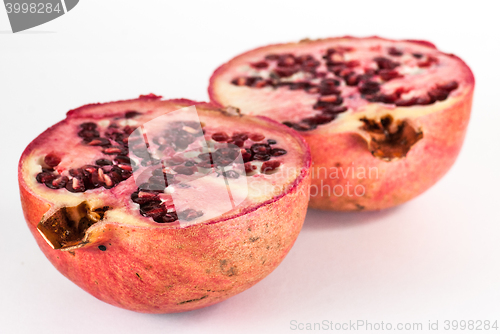 Image of two halfs ripe pomegranate fruit isolated on white background cutout