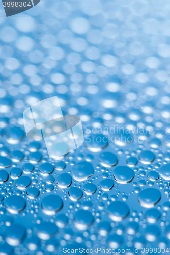 Image of close-up of water drops on the blue background 