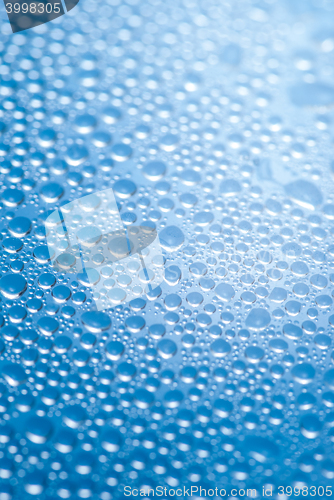 Image of close-up of water drops on the blue background 