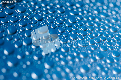 Image of close-up of water drops on the blue background 