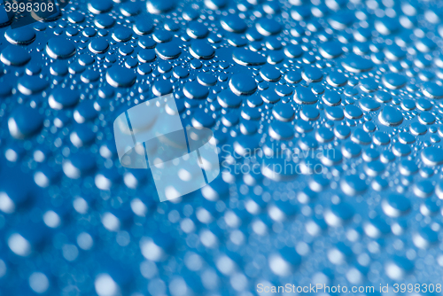 Image of close-up of water drops on the blue background 