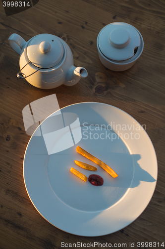 Image of French fries with ketchup and on wooden table. Top view sunny evening