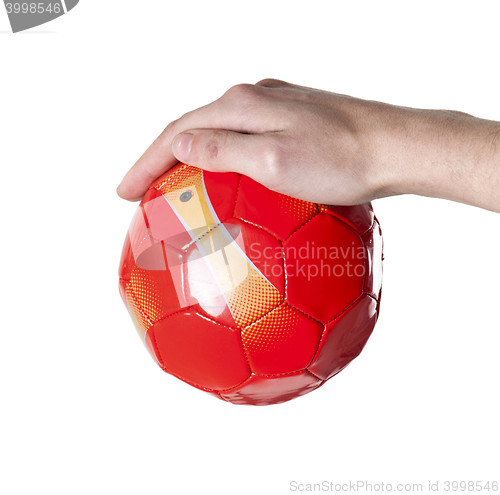 Image of small soccer red ball in hand. Isolated