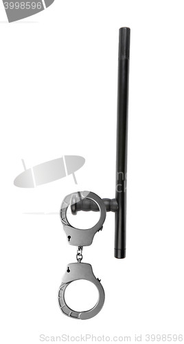 Image of Rubber baton lying and handcuffs on a white background