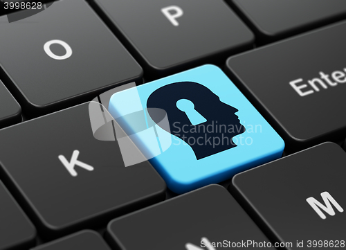 Image of Marketing concept: Head With Keyhole on computer keyboard background