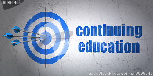 Image of Learning concept: target and Continuing Education on wall background