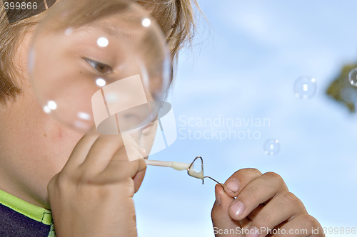 Image of boy blowing bubbles