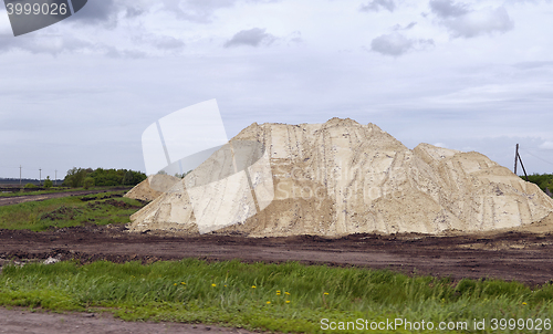 Image of  Yellow excavator working digging in sand quarry