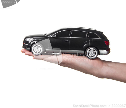 Image of man holding a toy car