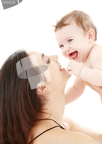 Image of laughing blue-eyed baby playing with mom