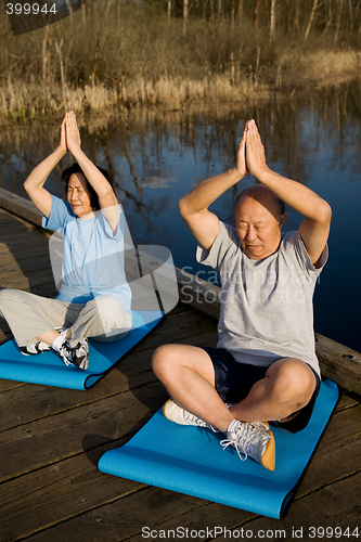 Image of Senior asian couple exercising