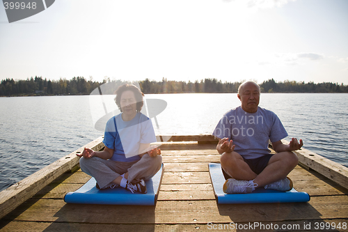 Image of Senior asian couple exercising