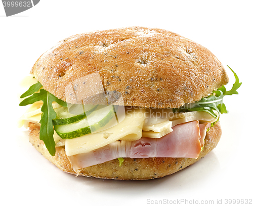 Image of breakfast sandwich with smoked meat, cheese and cucumber