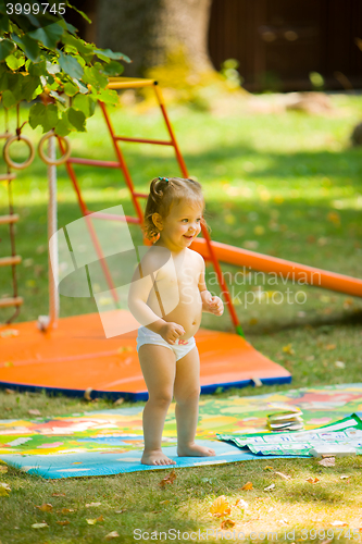 Image of The little baby girl playing at outdoor playground