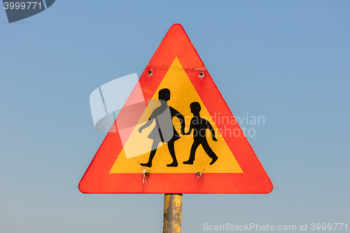 Image of Warning sign of children crossing street from school