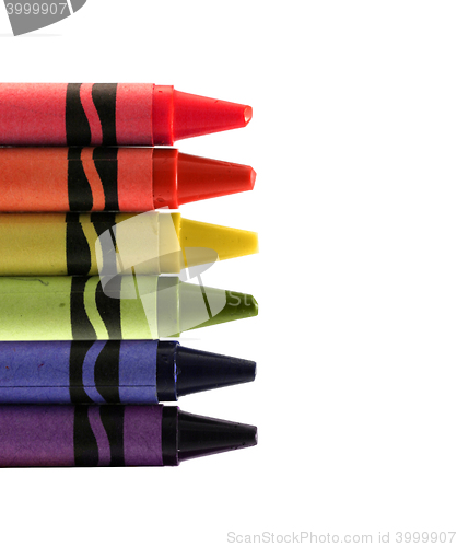 Image of six used colored vax crayons form rainbow