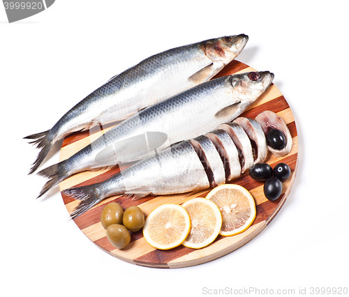 Image of sliced herring on wooden plate