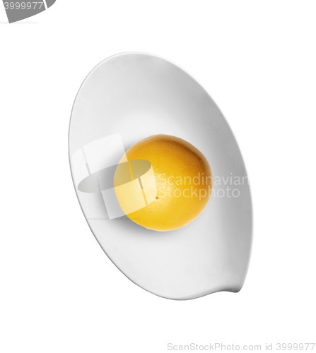 Image of lemon on plate isolated over white
