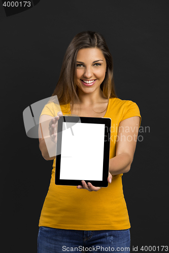 Image of Woman holding and showing a tablet