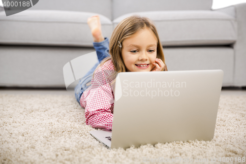 Image of Little girl working with a laptop