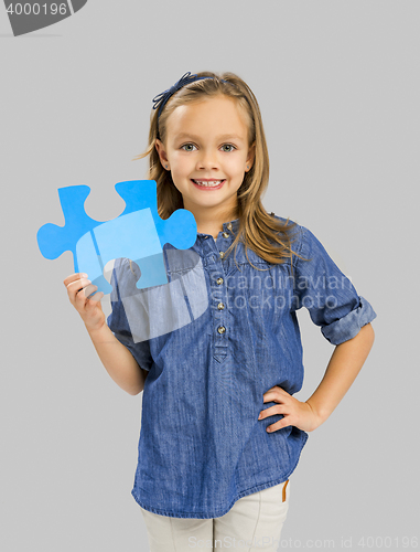 Image of Girl holding a puzzle