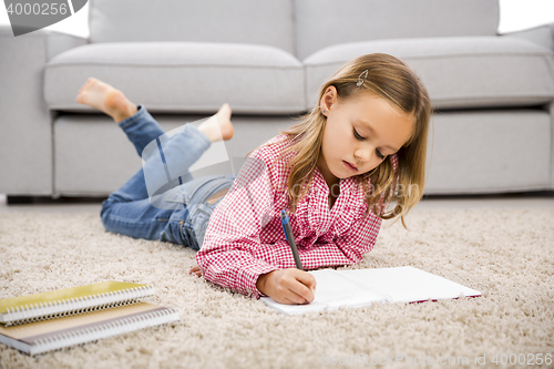 Image of Little girl making homework