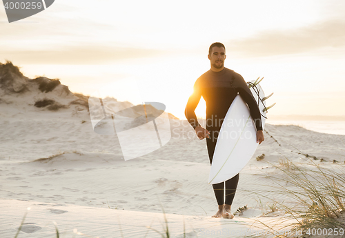 Image of A surfer with his surfboard 