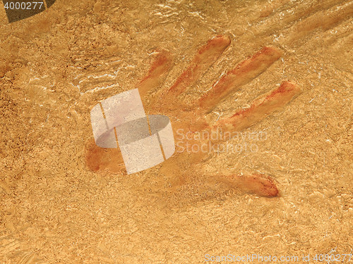 Image of Red hand print on stone