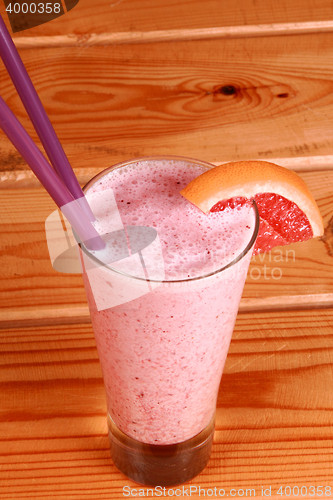 Image of milkshake on wooden background