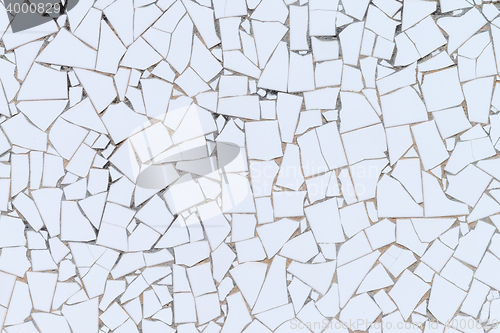 Image of White broken tiles wall