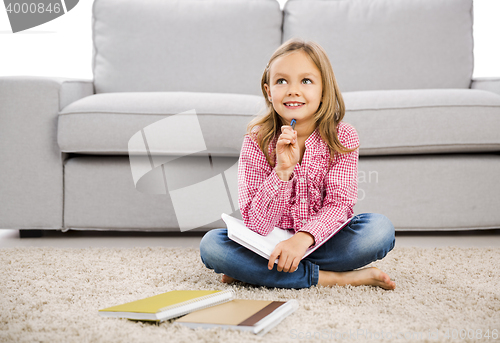 Image of Little girl making homework