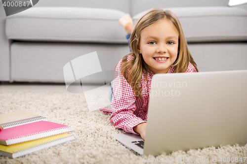 Image of Little girl working with a laptop