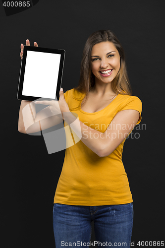 Image of Woman holding and showing a tablet