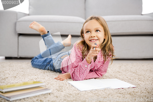 Image of Little girl making homework