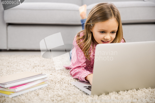 Image of Little girl working with a laptop