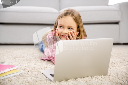 Image of Little girl working with a laptop