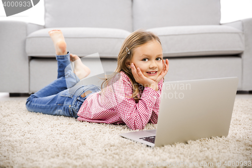 Image of Little girl working with a laptop