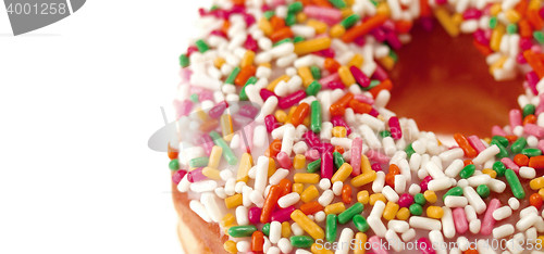 Image of Pink Iced Doughnut covered in sprinkles isolated
