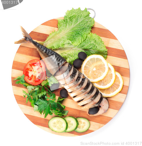 Image of sliced herring on wooden plate