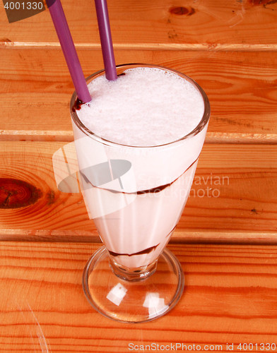 Image of milkshake on wooden background