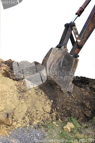 Image of Excavator bucket digging a trench in the dirt ground